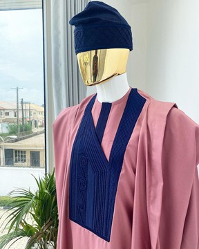 A light beige agbada with a navy blue embroidery design