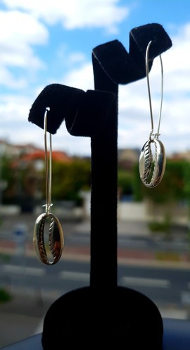 Pretty pair of silver colored cowrie earrings
