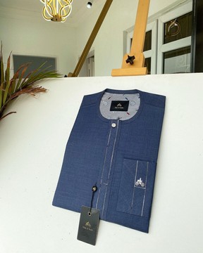 A navy blue kaftan with an interlocking patch pocket design.