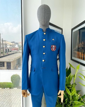 An azure blue, long sleeve safari suit, hand embroidery metal wire badge