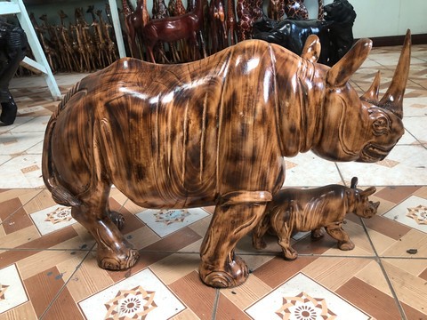 Mother rhino and calf curving