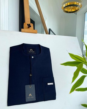 A midnight blue, front flap with clear view Swarovski button details  senator kaftan native.