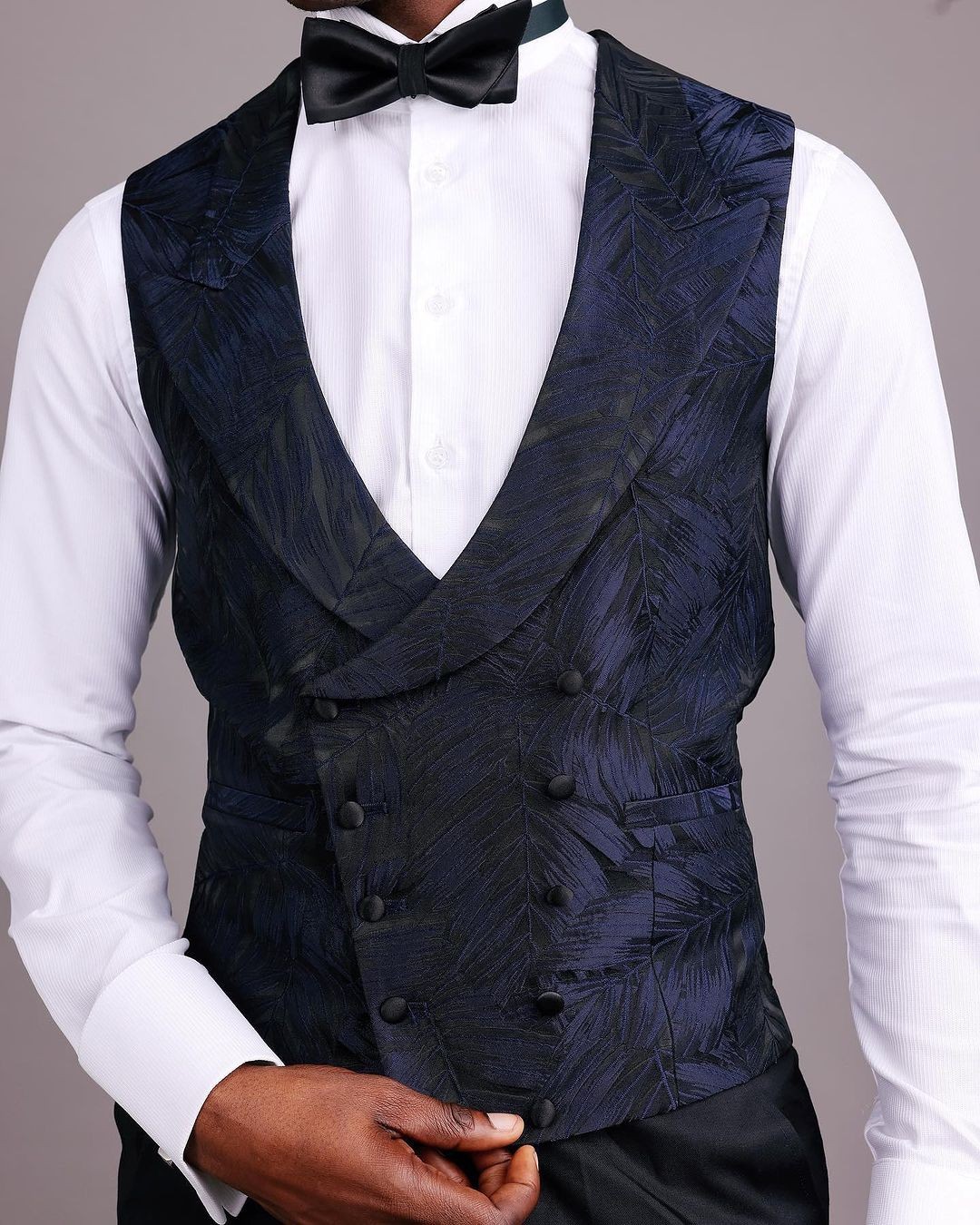 A double breasted, curved peak lapel waistcoat by dejiandkola
