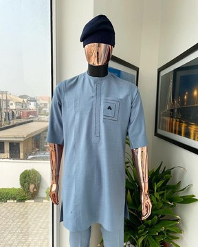 A Carolina blue, layered rectangle and square embrodery flap &amp; pocket detailing kaftan
