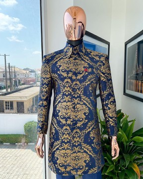 A gold and blue “Mandarin” jacquard floral safari suit &amp; navy blue jacquard pant trousers.