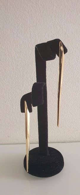 A pair of simple and elegant gold colored earrings