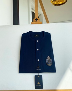 A midnight blue kaftan, buttonfront flap, hand embroidery patch detailing