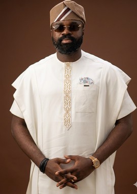 white Agbada and Traditional fila cap