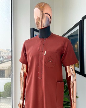 An amber orange, paisley mountain top patch pocket detailing kaftan native.