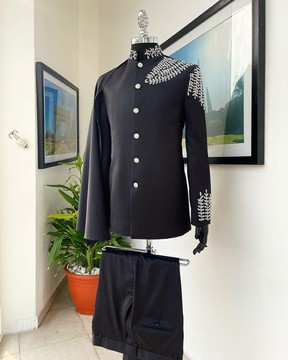A charcoal black, hand “Ide” silver metal wire embrodery, right hand sache safari Suit