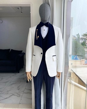 An ivory white shawl lapel square pattern jacquard tuxedo suit