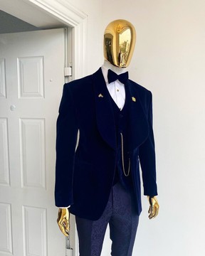 A shawl lapel midnight blue soaked velvet tuxedo suit.