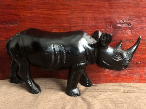 Wooden black rhino curving