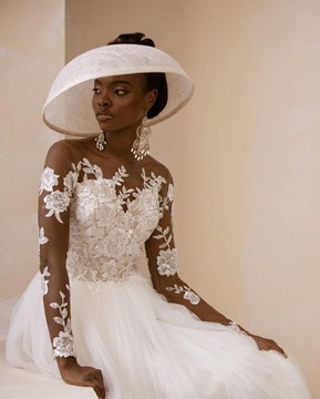 The “Monica” ivory top patterned long sleeve tulle wedding gown
