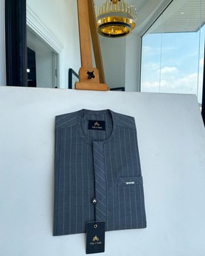 An iron grey pencil stripe, front flap &amp; slant pocket detailing senator kaftan native.