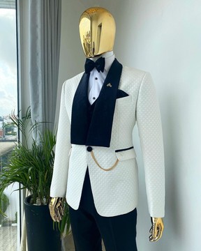 An ivory white shawl lapel square pattern jacquard tuxedo suit with black velvet lapel