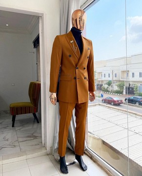 A burnt orange double breasted peak lapel suit
