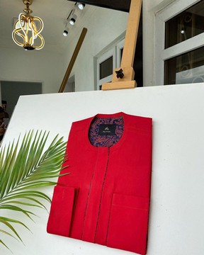 A Tomato Red Kaftan, With mixed blue and red paisley detailing.