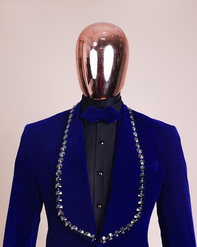 A charcoal black, floral patterned shawl lapel, single button smoking tuxedo suit