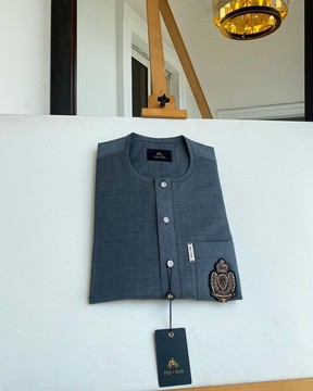An Irish grey kaftan, button front flap, hand embroidery patch detailing