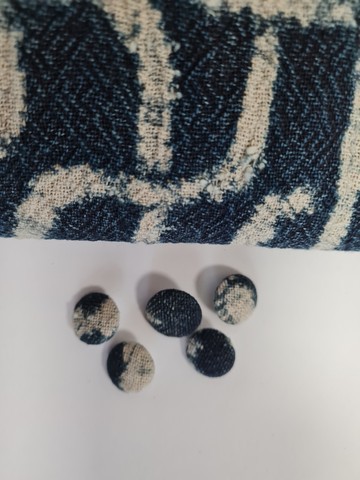 Button covered with traditional Ndop loincloth fabric