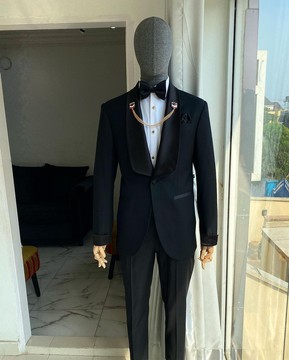 An charcoal black dinner shawl lapel tuxedo suit