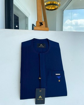 A navy blue, front flap &amp; slant pocket with inverted tree detailing senator kaftan native.