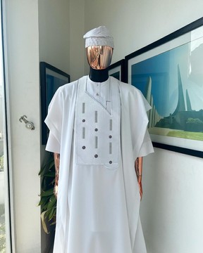 A white , a layered dropping Swarovski pleats, dotted metallic wire embroidery details agbada.