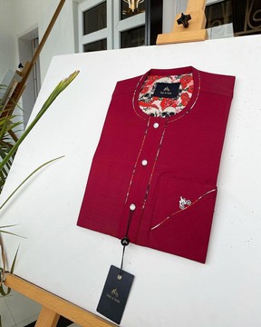 A Burgundy Kaftan, styled with silver Swarovski buttons.