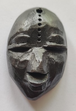 ebony wood fridge magnet carved in the shape of a face - fridge magnet