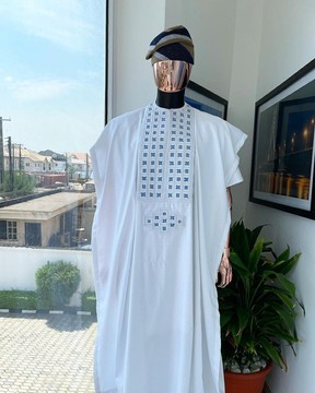 A white, connected square embroidery design with skye blue agbada, buba &amp; sokoto