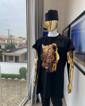 A charcoal black “daftan” with a tiger prints &amp; black Fulani hat