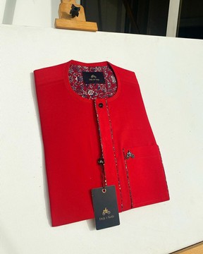 A tomato red flat design senator Kaftan with a black Swarovski button detailing.