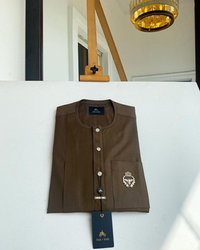 A brown kaftan, button front flap, gold metal detailing &amp; silver 12mm Swarovski button.