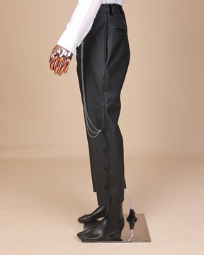 A black leather, knitted &amp; outer layered pant Trouser with side opening.
