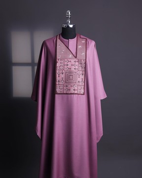 An orchid purple, “Egyptian architecture” embrodery details agbada