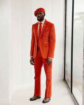 A vermillion orange corduroy, notch lapel with gold zipping details suit