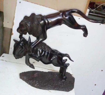 Preying lion on a buffalo sculpture/ table top jungle sculptures / unique home decor piece