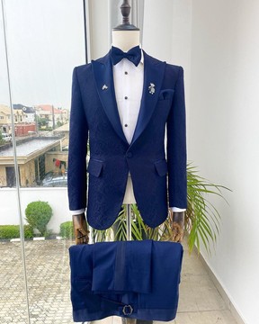 A midnight blue peak lapel floral jacquard tuxedo suit.