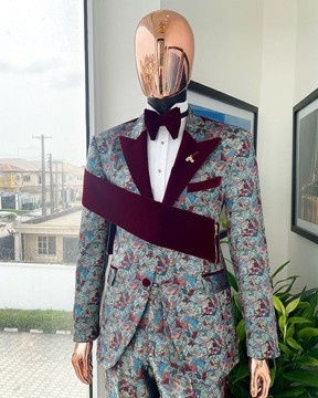 An “octopus” floral paisley tuxedo with right side strap mahogany red soaked velvet peak lapel suit