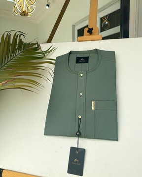 An aqua green Men’s tailored kaftan